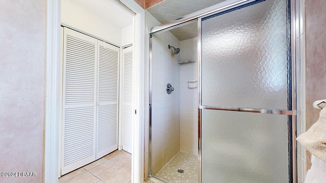 bathroom with tile patterned flooring and an enclosed shower