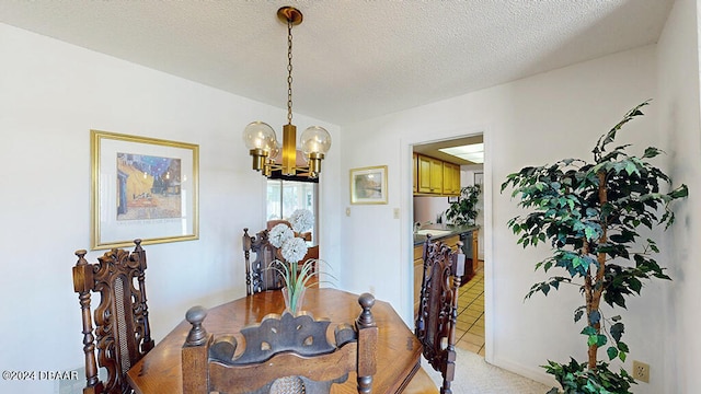 dining room featuring a textured ceiling, light tile patterned floors, and a notable chandelier