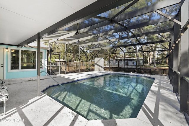 view of swimming pool featuring a lanai and a patio area