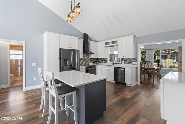 kitchen with white cabinetry, dishwashing machine, stainless steel fridge, and hanging light fixtures