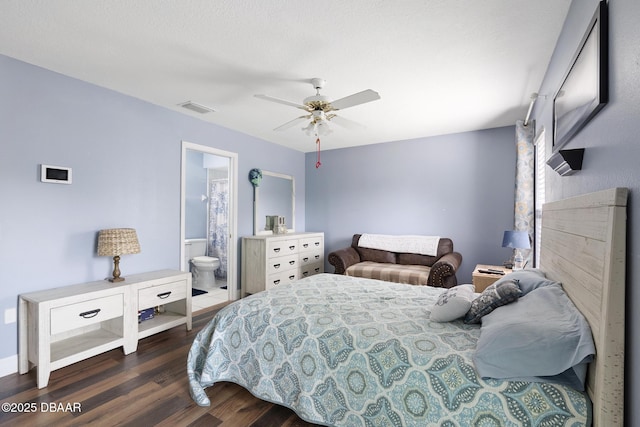 bedroom with ensuite bath, ceiling fan, and dark hardwood / wood-style flooring