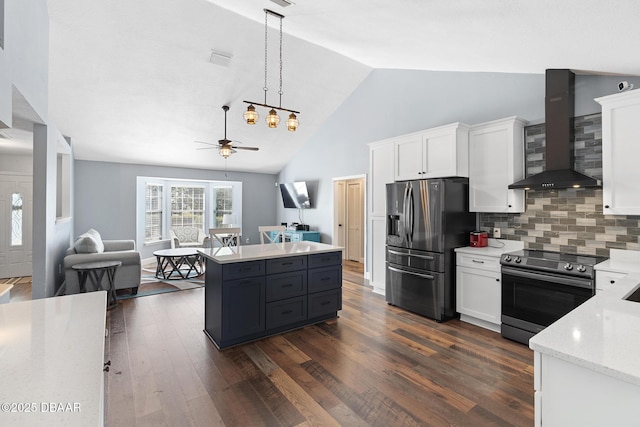 kitchen with backsplash, wall chimney range hood, pendant lighting, white cabinetry, and appliances with stainless steel finishes