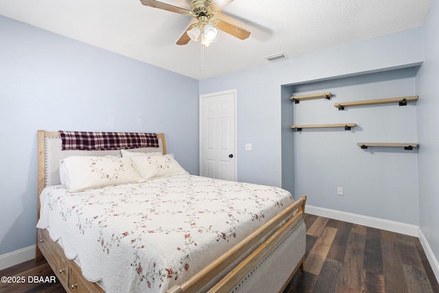 bedroom with ceiling fan and dark wood-type flooring