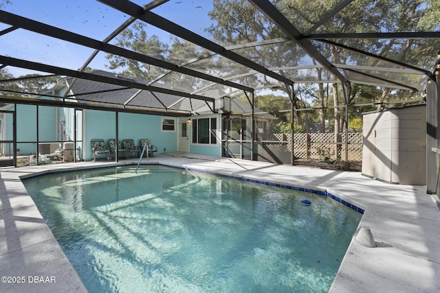 view of pool featuring glass enclosure and a patio area