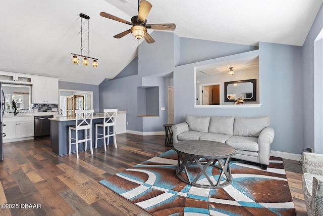 living room featuring vaulted ceiling, ceiling fan, and dark hardwood / wood-style floors