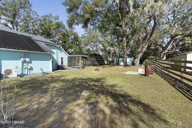 view of yard featuring ac unit and a sunroom