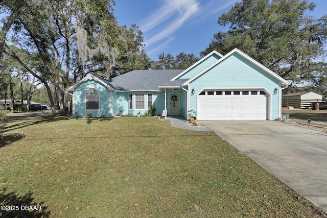 view of front of property featuring a front lawn and a garage