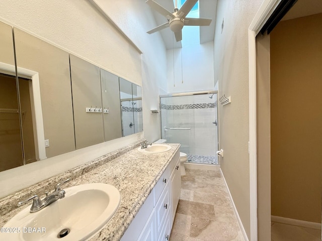 full bathroom with toilet, a sink, a stall shower, and ceiling fan