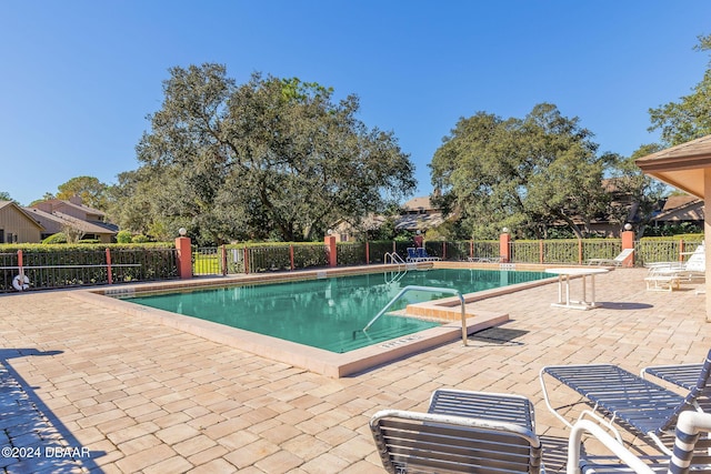 pool featuring a patio area and fence