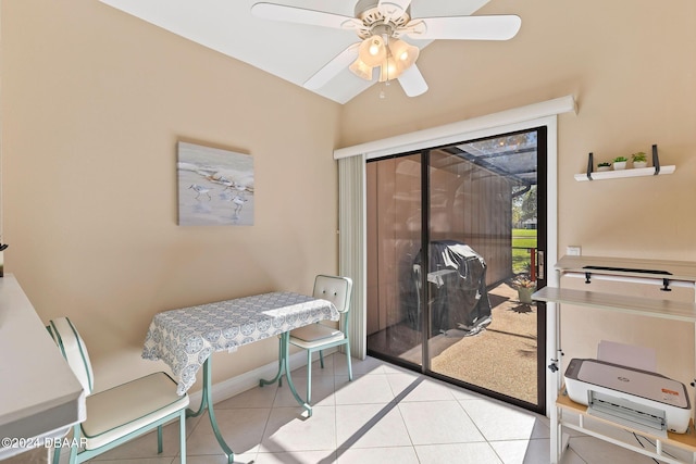 tiled dining room with a ceiling fan and vaulted ceiling
