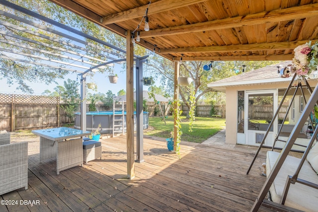 wooden deck featuring a pergola and a fenced in pool