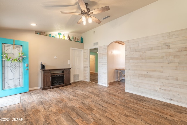 unfurnished living room featuring hardwood / wood-style floors, vaulted ceiling, and ceiling fan