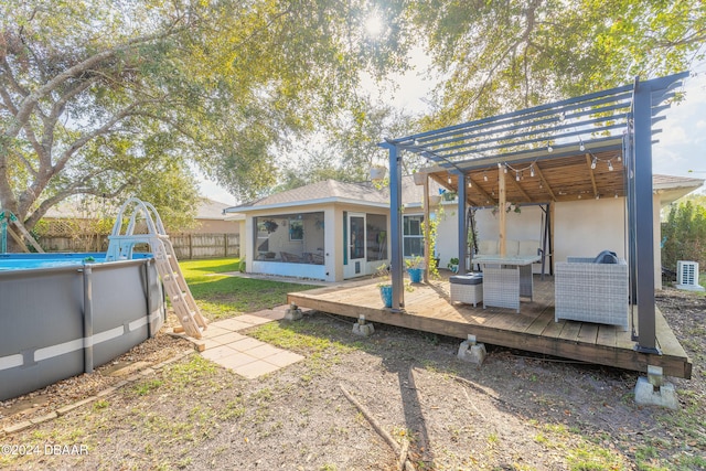 view of yard with a swimming pool side deck and a sunroom