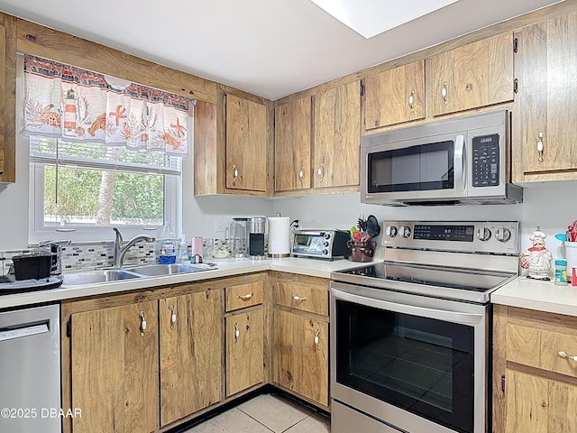 420 Banana Cay Dr Unit A, South Daytona, FL 32119 - kitchen with a sink, light countertops, a toaster, stainless steel appliances, and light tile patterned flooring