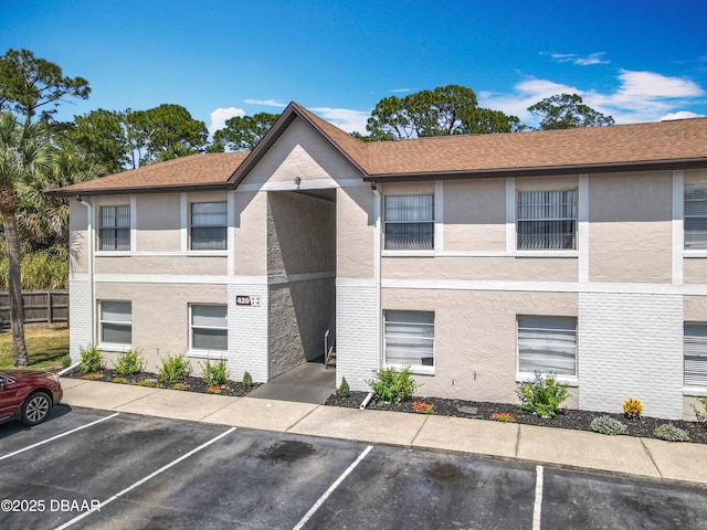 420 Banana Cay Dr Unit A, South Daytona, FL 32119 - view of building exterior featuring uncovered parking and fence