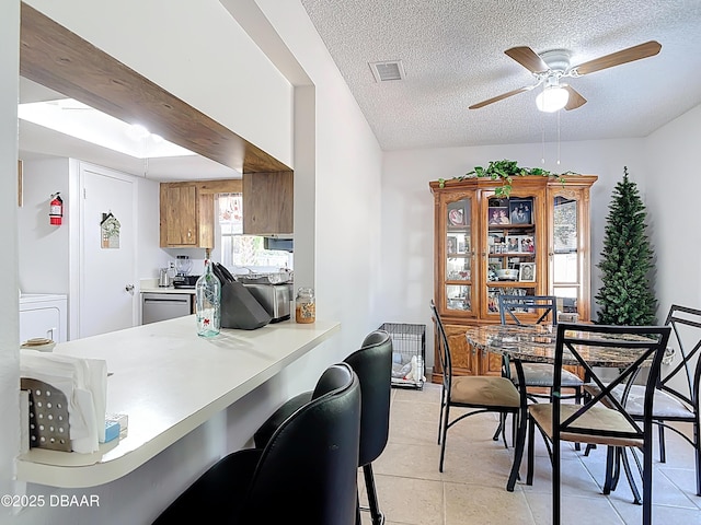 420 Banana Cay Dr Unit A, South Daytona, FL 32119 - dining room featuring visible vents, a textured ceiling, ceiling fan, and light tile patterned floors