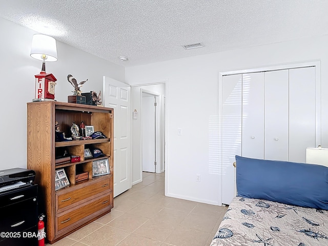 420 Banana Cay Dr Unit A, South Daytona, FL 32119 - bedroom featuring light tile patterned flooring, a textured ceiling, visible vents, and a closet