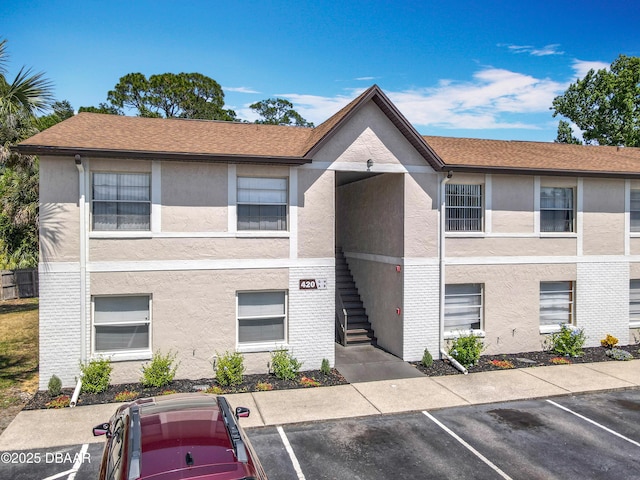 420 Banana Cay Dr Unit A, South Daytona, FL 32119 - view of building exterior featuring uncovered parking and stairway