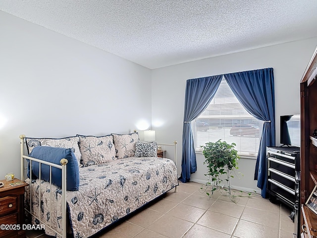 420 Banana Cay Dr Unit A, South Daytona, FL 32119 - bedroom with a textured ceiling and light tile patterned flooring