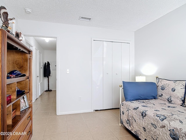 420 Banana Cay Dr Unit A, South Daytona, FL 32119 - bedroom with a textured ceiling, a closet, light tile patterned flooring, and visible vents