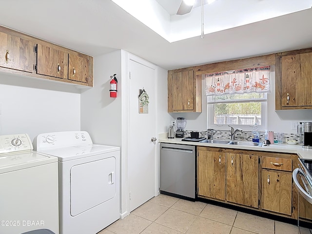 420 Banana Cay Dr Unit A, South Daytona, FL 32119 - laundry room featuring light tile patterned floors, laundry area, washing machine and dryer, and a sink