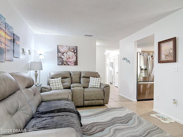 420 Banana Cay Dr Unit A, South Daytona, FL 32119 - living room with baseboards, a textured ceiling, visible vents, and light tile patterned floors