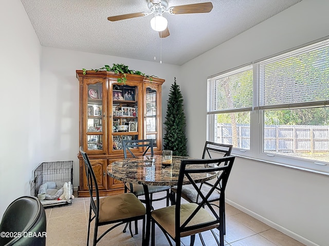 420 Banana Cay Dr Unit A, South Daytona, FL 32119 - dining room with light tile patterned floors, baseboards, ceiling fan, and a textured ceiling
