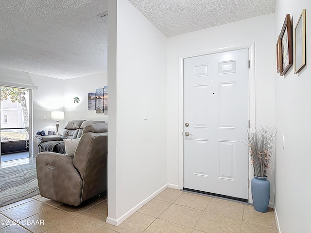420 Banana Cay Dr Unit A, South Daytona, FL 32119 - foyer featuring baseboards, a textured ceiling, and light tile patterned floors