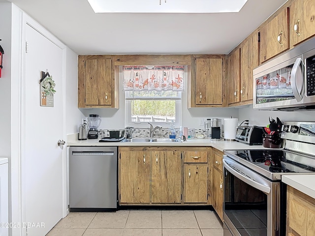 420 Banana Cay Dr Unit A, South Daytona, FL 32119 - kitchen with light countertops, light tile patterned floors, appliances with stainless steel finishes, and a sink