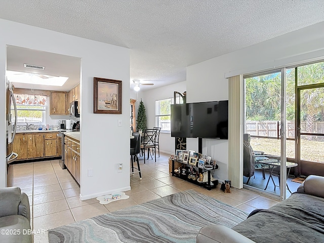 420 Banana Cay Dr Unit A, South Daytona, FL 32119 - living area featuring a ceiling fan, a textured ceiling, visible vents, baseboards, and light tile patterned flooring