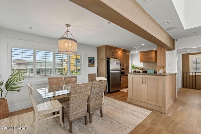 dining area featuring baseboards, light wood finished floors, a chandelier, and recessed lighting