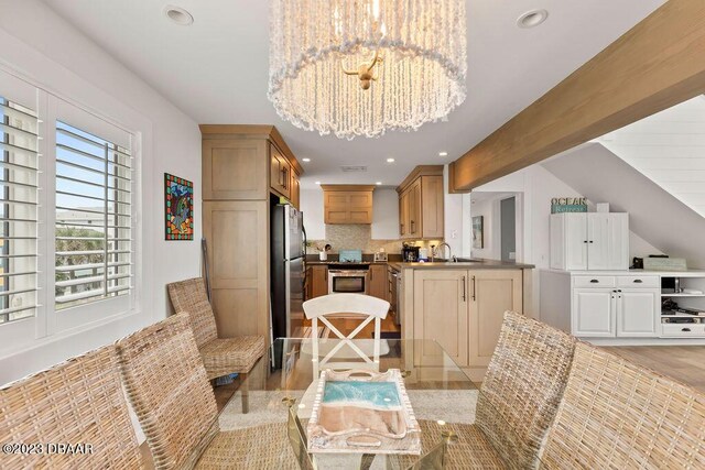 dining space with light wood finished floors, an inviting chandelier, and recessed lighting