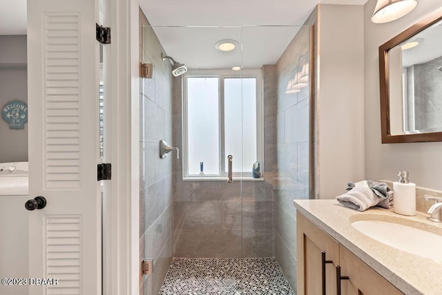 bathroom with vanity, plenty of natural light, and a stall shower
