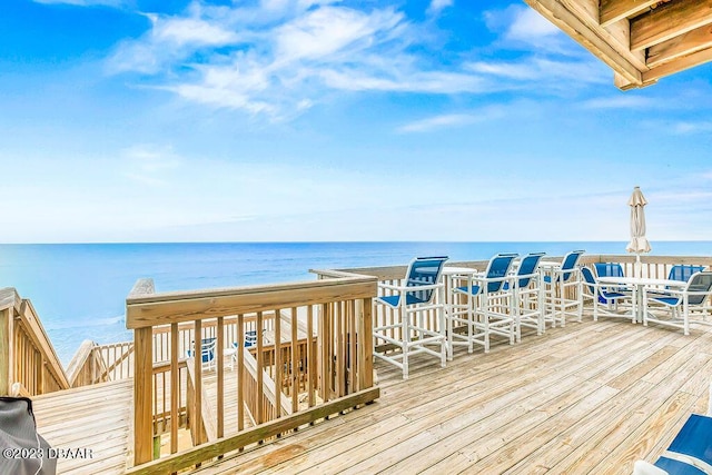 wooden terrace featuring a water view