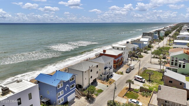 drone / aerial view featuring a water view and a beach view