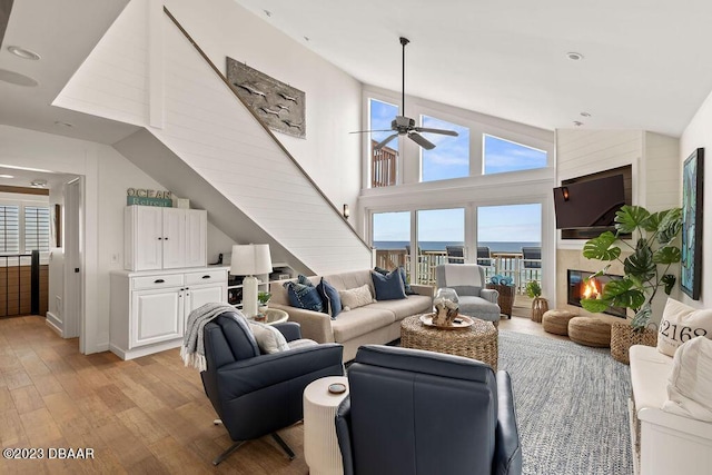 living room featuring ceiling fan, recessed lighting, a healthy amount of sunlight, and light wood-style floors