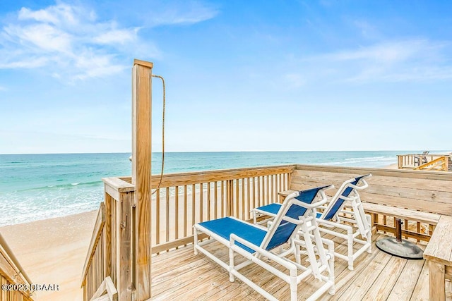 view of property's community featuring a beach view and a water view