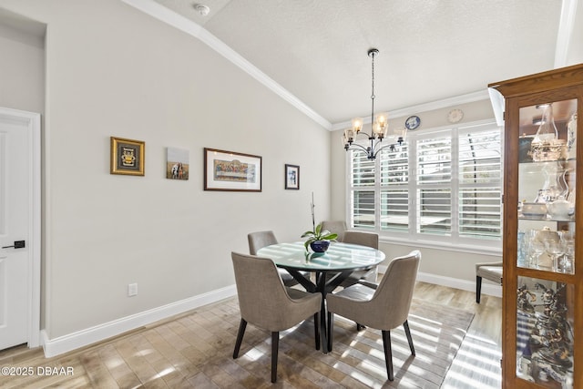 dining area with lofted ceiling, hardwood / wood-style flooring, an inviting chandelier, ornamental molding, and a textured ceiling