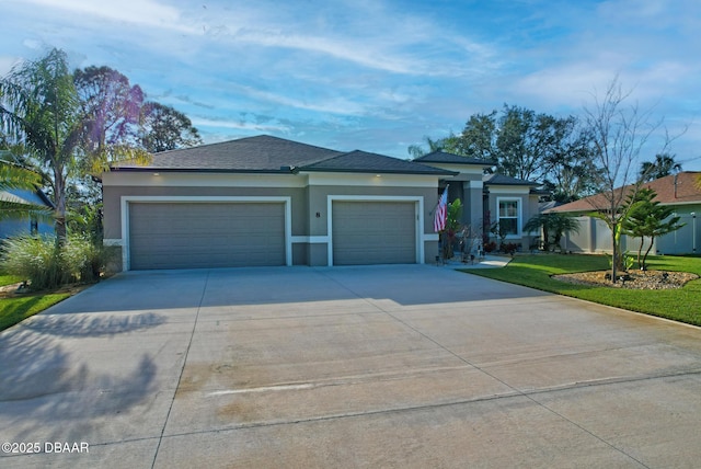 view of front of home with a garage and a front lawn