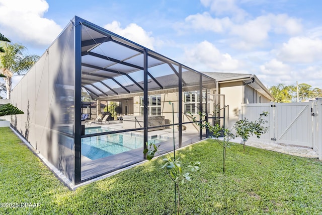 rear view of house featuring a fenced in pool, a patio, a lanai, and a lawn