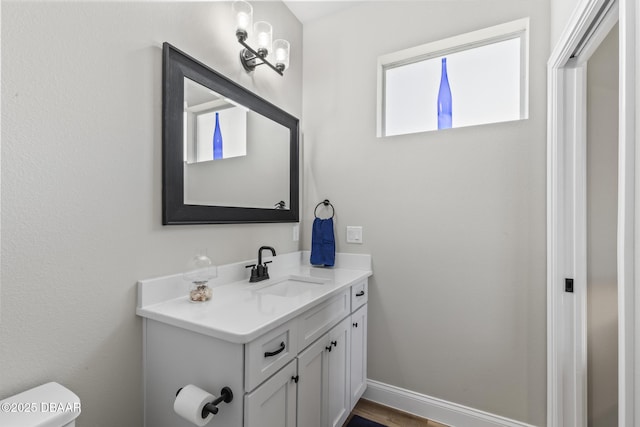 bathroom featuring vanity and toilet