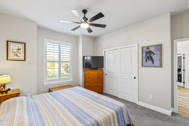 carpeted bedroom featuring ceiling fan and a closet