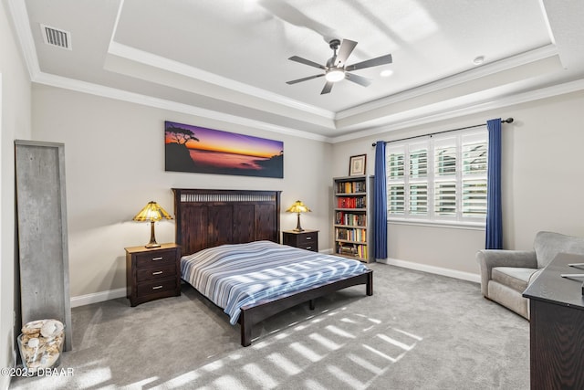 bedroom with crown molding, a raised ceiling, and light carpet