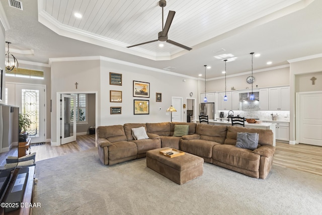 living room with a raised ceiling, crown molding, wood ceiling, and light hardwood / wood-style floors