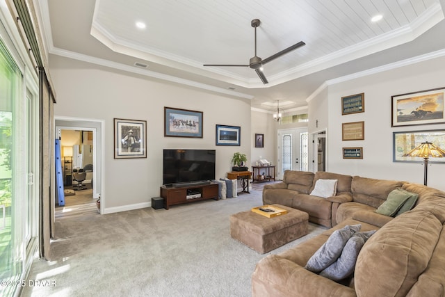 living room with crown molding, wood ceiling, a raised ceiling, and light carpet