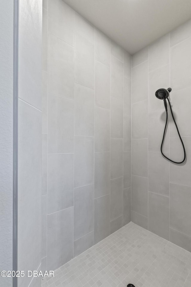 bathroom with a tile shower