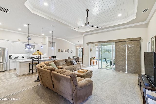 living room with crown molding and a raised ceiling