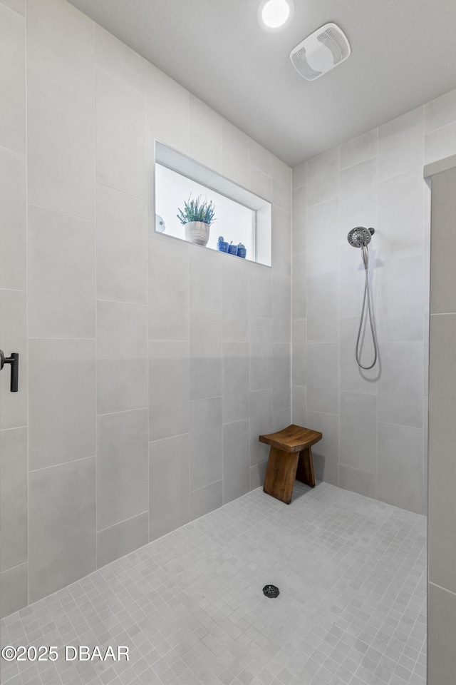 bathroom with a tile shower