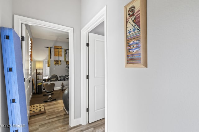 hallway with light hardwood / wood-style flooring