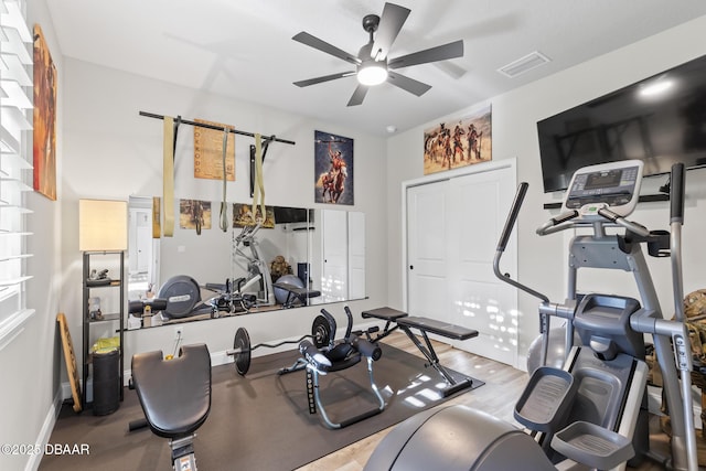 workout area with ceiling fan and light hardwood / wood-style flooring